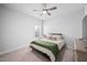 Cozy bedroom featuring carpet, a ceiling fan, and a bed with an eye-catching green blanket at 2404 Glade Mill Ct, Fuquay Varina, NC 27526