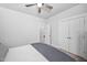Bright bedroom featuring carpet, a ceiling fan, and white bedroom doors and trim at 2404 Glade Mill Ct, Fuquay Varina, NC 27526