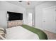 Bright bedroom featuring carpet, a bed with a green blanket and television on a wooden dresser at 2404 Glade Mill Ct, Fuquay Varina, NC 27526