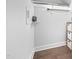 Walk-in closet featuring wood floors, overhead lighting, hanging racks, and a shelving unit at 2404 Glade Mill Ct, Fuquay Varina, NC 27526