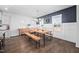 Bright dining room with a rustic table, industrial benches, and a dark blue accent wall with white wainscoting at 2404 Glade Mill Ct, Fuquay Varina, NC 27526