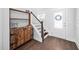 Bright foyer featuring hardwood floors, wooden cabinet and stairs, creating a welcoming entrance at 2404 Glade Mill Ct, Fuquay Varina, NC 27526