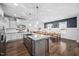 Modern kitchen with granite countertops, stainless steel appliances, and an island with seating at 2404 Glade Mill Ct, Fuquay Varina, NC 27526