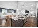 Open kitchen with an island, stainless steel sink, adjacent to a dining area, ideal for entertaining at 2404 Glade Mill Ct, Fuquay Varina, NC 27526