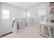 Versatile loft area with natural light, perfect for an office space or relaxation, featuring neutral carpet at 2404 Glade Mill Ct, Fuquay Varina, NC 27526