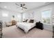 Spacious main bedroom with a ceiling fan, neutral decor, and ample natural light, offering a serene retreat at 2404 Glade Mill Ct, Fuquay Varina, NC 27526
