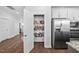 Walk-in pantry featuring ample shelving for organized storage, conveniently located next to the stainless steel refrigerator at 2404 Glade Mill Ct, Fuquay Varina, NC 27526