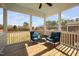 Relaxing screened porch showcasing wooden floors, furniture, and a fan at 2404 Glade Mill Ct, Fuquay Varina, NC 27526