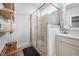 Main bathroom tile shower with glass door, offering a spa-like experience and modern elegance in design at 2404 Glade Mill Ct, Fuquay Varina, NC 27526