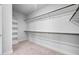Walk-in closet with shelving and hanging rods, providing ample storage space for clothes and accessories at 2404 Glade Mill Ct, Fuquay Varina, NC 27526