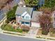 Birds-eye view of the brick home with a light-grey roof, blue shutters, attached garage and lush yard at 2428 Havershire Dr, Raleigh, NC 27613