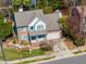 Aerial view showcases home, its attached garage, manicured lawn, and mature trees at 2428 Havershire Dr, Raleigh, NC 27613