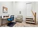 Basement with neutral carpet features a work space, patterned chair and access to the exterior at 2428 Havershire Dr, Raleigh, NC 27613