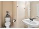 Well-maintained half bathroom with a modern sink, toilet, and neutral color scheme at 2428 Havershire Dr, Raleigh, NC 27613