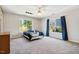 Spacious bedroom features large windows, plush carpet, and a ceiling fan at 2428 Havershire Dr, Raleigh, NC 27613