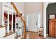 Inviting entryway featuring hardwood floors, stairway, and front door with sidelights at 2428 Havershire Dr, Raleigh, NC 27613