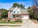 Lovely brick home with blue shutters, a well-maintained lawn, and a convenient attached garage at 2428 Havershire Dr, Raleigh, NC 27613