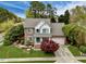 Charming two-story brick home with manicured lawn, light-grey roof, blue shutters, and attached garage at 2428 Havershire Dr, Raleigh, NC 27613