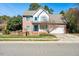 Beautiful two-story brick home featuring blue shutters, attached garage, and landscaped front yard at 2428 Havershire Dr, Raleigh, NC 27613