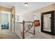 Upstairs hallway featuring a view of the stairs, and main bedroom with soft natural light at 2428 Havershire Dr, Raleigh, NC 27613