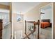 Upstairs hallway featuring a view of the stairs, and main bedroom with soft natural light at 2428 Havershire Dr, Raleigh, NC 27613