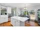 Well-lit kitchen with stainless appliances, hardwood floors, and backyard views at 2428 Havershire Dr, Raleigh, NC 27613