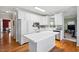 Modern kitchen with white cabinetry, stainless steel appliances, and a breakfast bar at 2428 Havershire Dr, Raleigh, NC 27613