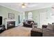 Inviting living room with a fireplace, plush carpeting, and a comfortable seating area at 2428 Havershire Dr, Raleigh, NC 27613
