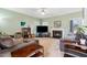 Spacious living room featuring a fireplace, comfortable seating, and a ceiling fan at 2428 Havershire Dr, Raleigh, NC 27613