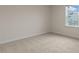 Bright bedroom featuring neutral walls and plush carpet, with a window offering plenty of natural light at 265 Umstead St, Sanford, NC 27330