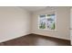 Bedroom with hardwood floors, large windows providing natural light, and white trim throughout at 265 Umstead St, Sanford, NC 27330