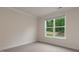 A simple bedroom with neutral walls and trim with a large window at 265 Umstead St, Sanford, NC 27330