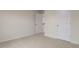 Bedroom with neutral walls and carpet, featuring white door and trim, offering a clean and spacious feel at 265 Umstead St, Sanford, NC 27330