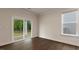 Sunlit living room featuring a sliding glass door, wood floors, and large window showcasing the backyard at 265 Umstead St, Sanford, NC 27330