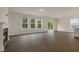 Spacious living room with a fireplace, three large windows, wood floors, and natural light at 265 Umstead St, Sanford, NC 27330