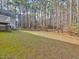 A large backyard with lots of tall trees and grass at 273 Homestead Way, Clayton, NC 27527