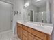 Bathroom features a double sink vanity with wooden cabinets and large mirror at 273 Homestead Way, Clayton, NC 27527