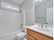 Cozy bathroom features a shower-tub combo, white toilet and wooden vanity at 273 Homestead Way, Clayton, NC 27527