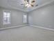 Large main bedroom featuring recessed lighting, tray ceiling, neutral carpet, and bright, large windows at 273 Homestead Way, Clayton, NC 27527