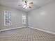 Carpeted bedroom is illuminated by a modern ceiling fan and two windows at 273 Homestead Way, Clayton, NC 27527