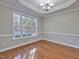 Bright dining room with hardwood floors, large window, elegant chandelier, and tray ceiling at 273 Homestead Way, Clayton, NC 27527