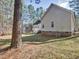 View of the home's exterior showcasing the backyard and surrounding trees at 273 Homestead Way, Clayton, NC 27527