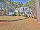 Charming two-story home with mature trees, a manicured lawn, attached garage, and inviting front porch at 273 Homestead Way, Clayton, NC 27527
