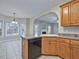 Open-concept kitchen with modern appliances and a breakfast bar overlooking the dining area at 273 Homestead Way, Clayton, NC 27527