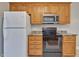 Well-equipped kitchen with stainless steel appliances, wooden cabinets, and plenty of counter space at 273 Homestead Way, Clayton, NC 27527