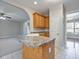 Functional kitchen layout with a peninsula, wood cabinetry, and an open view to adjacent living spaces at 273 Homestead Way, Clayton, NC 27527