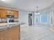 Bright kitchen with a tile floor, wood cabinetry, a breakfast nook, and a view of the backyard at 273 Homestead Way, Clayton, NC 27527