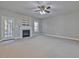 Spacious living room featuring a cozy fireplace and a ceiling fan for added comfort at 273 Homestead Way, Clayton, NC 27527