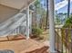 Inviting front porch with elegant white columns, black railings, and a warm wood floor at 273 Homestead Way, Clayton, NC 27527
