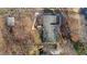 Aerial view of home with a dark roof, surrounded by trees, and a walkway leading to the front at 3307 Altamahaw Church St, Elon, NC 27244